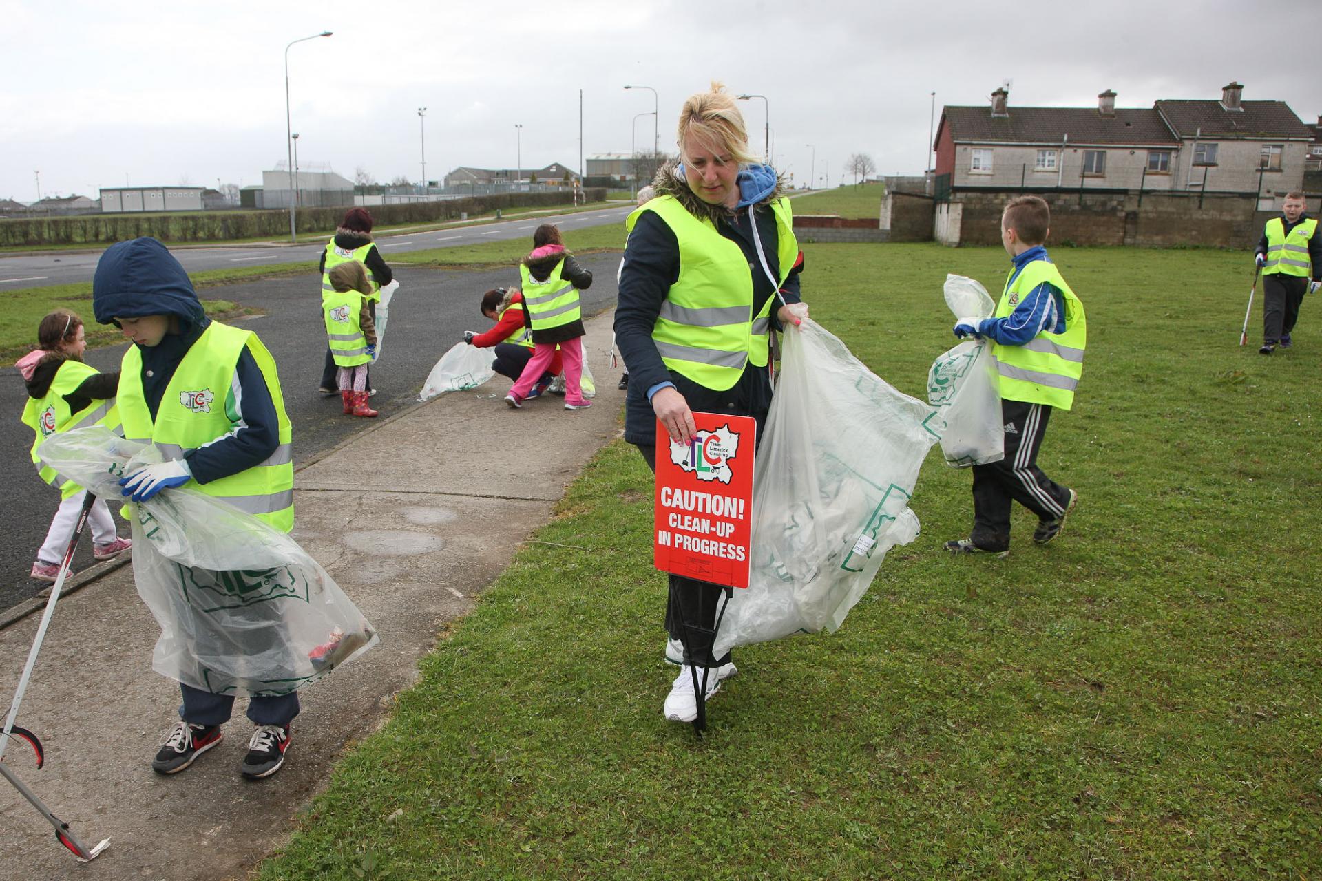 A woman and local children tidy up