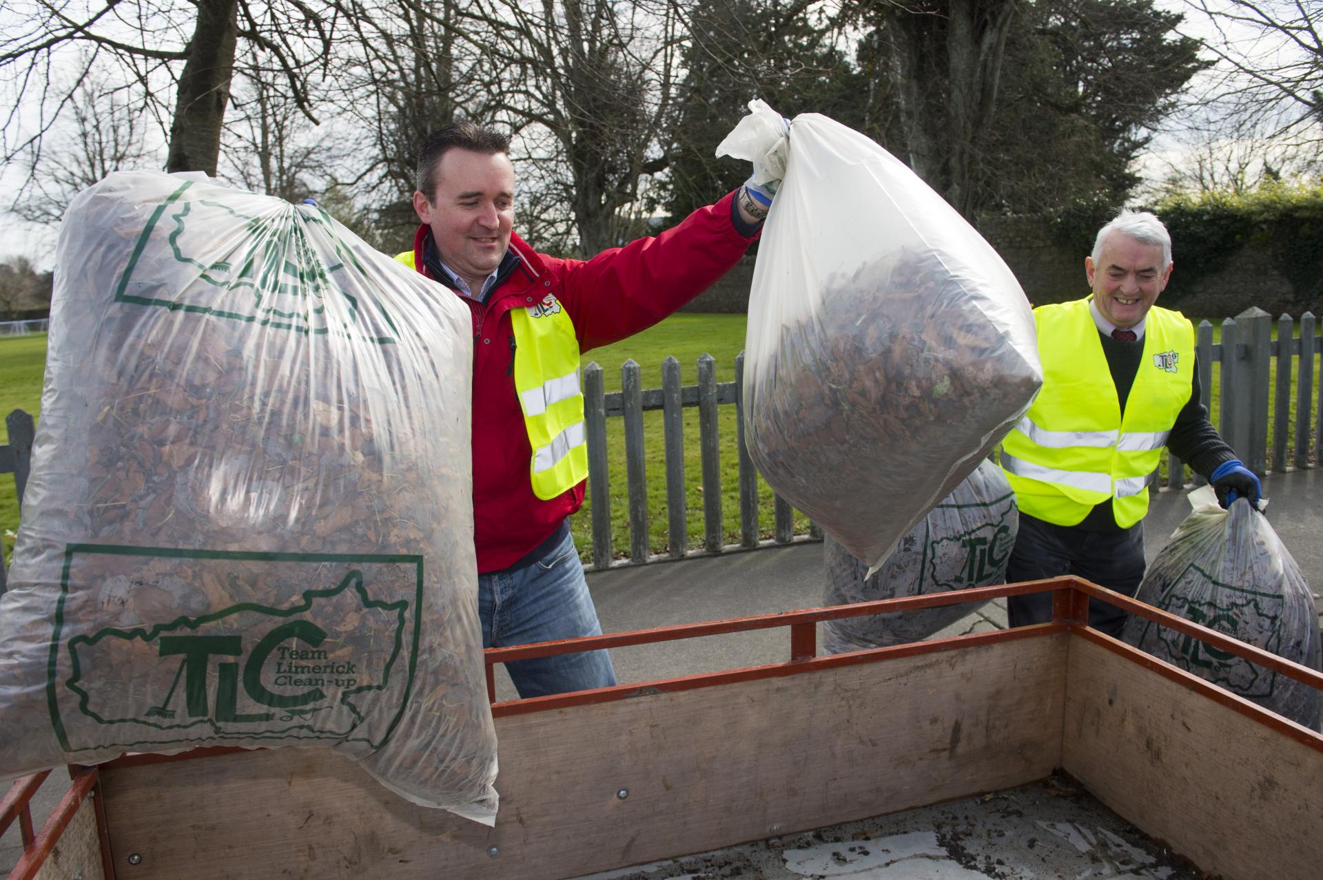 Two men with bags of rubbish at Adare