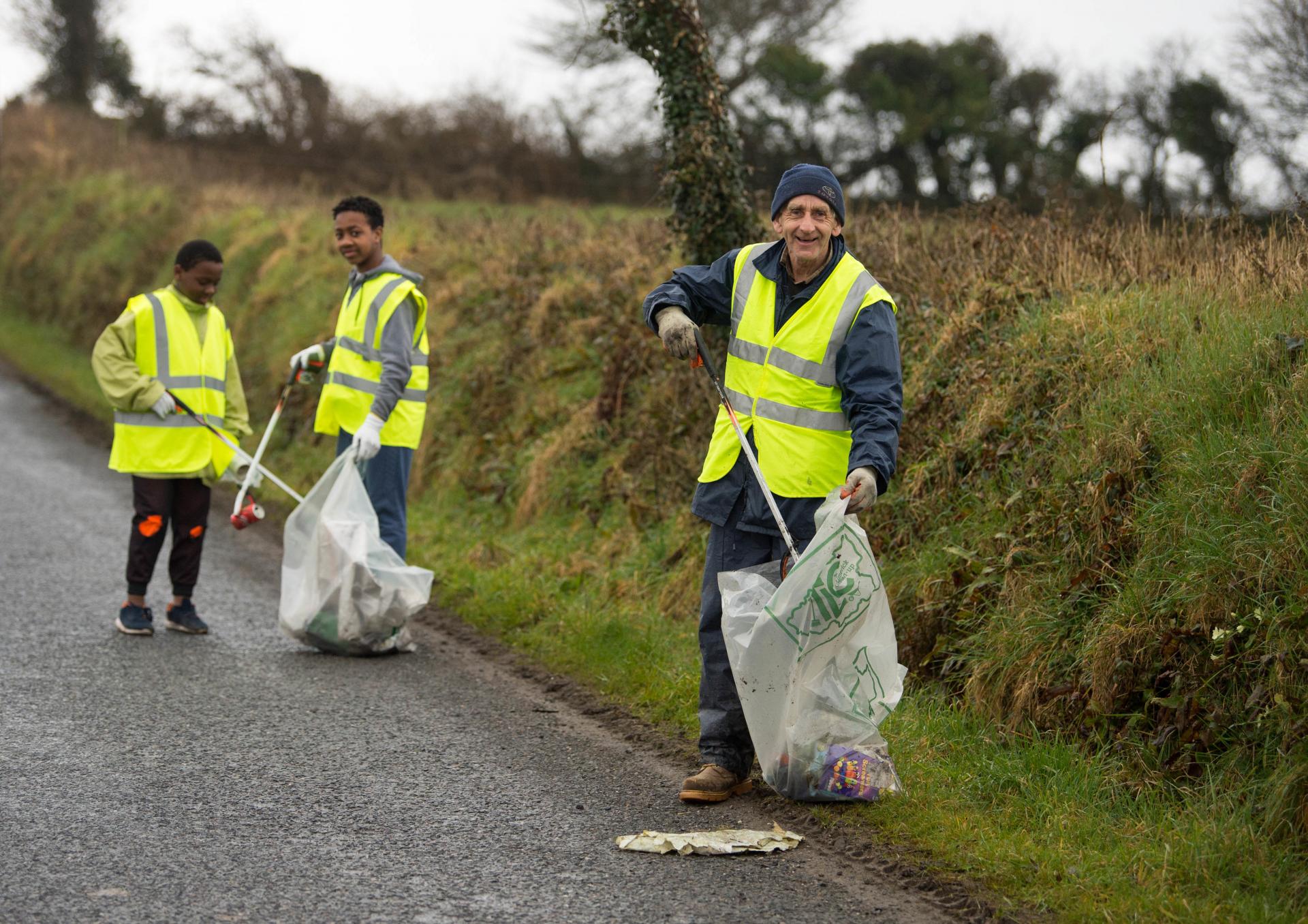 An elder man and two youths clean up at Ballyhahill