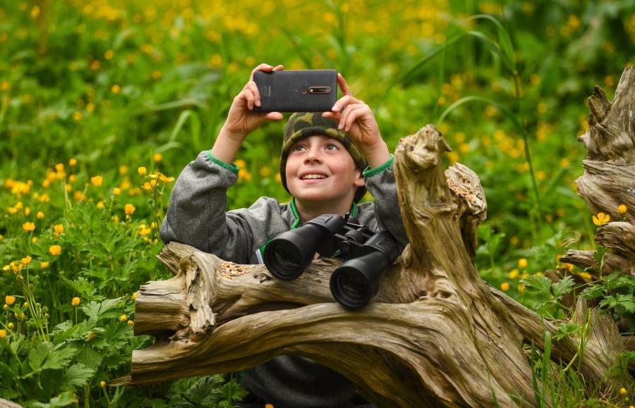 A boy taking a photo 